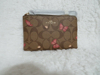 Picture of Coach Signature Canvas Corner Zip Wristlet with Smooth Leather