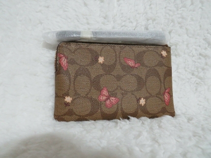 Picture of Coach Signature Canvas Corner Zip Wristlet with Smooth Leather